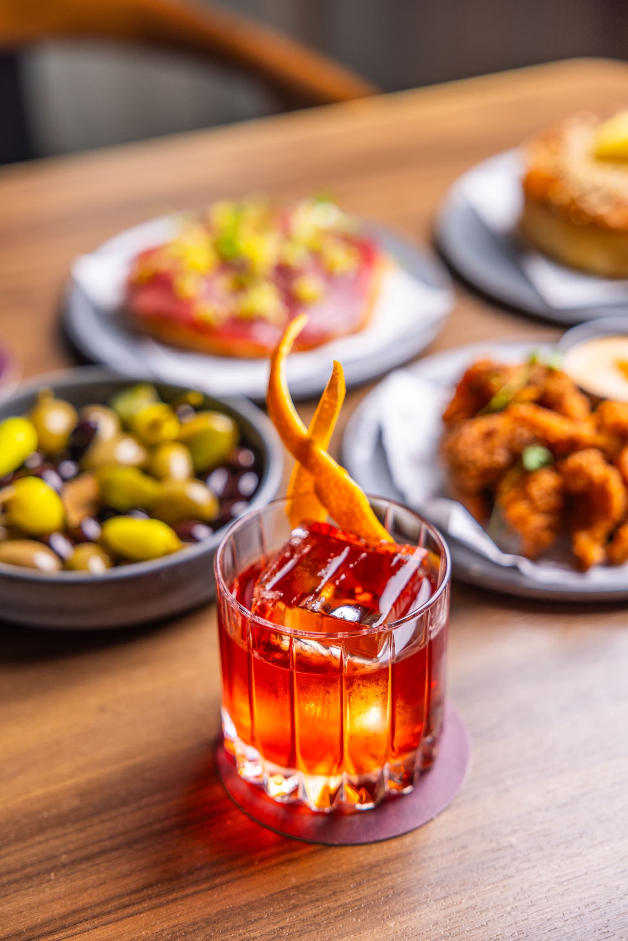 Negroni cocktail with bar snacks